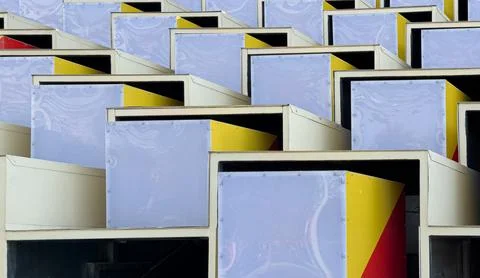 A close-up view of a colorful, geometric structure made of various sized sq.. Фото