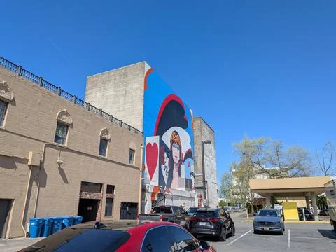 Close-up view of a colorful mural featuring a woman framed by hearts Fotos Stock