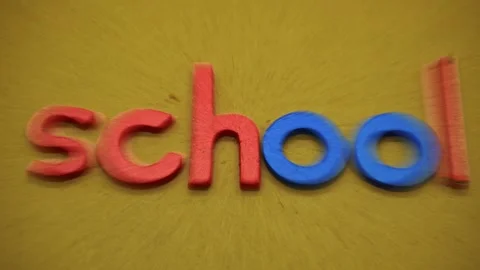 A close up view of colorful plastic letters forming the word school on a te.. Stock Footage 345127001