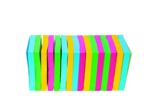 Close up view of colorful post-it notes block isolated on white background. Stock Photos