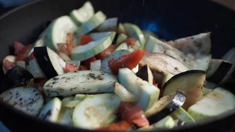 Close up view of colorful steaming vegetables frying on a pan being mixed Stock Footage 114059246