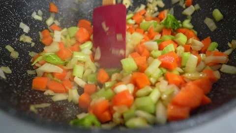 Close up view of colorful steaming vegetables frying on a pan being mixed and Stock Footage 150208519
