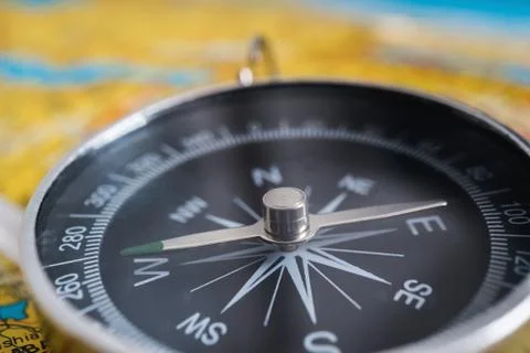 Close up view on compass and map in background. Stock Photos