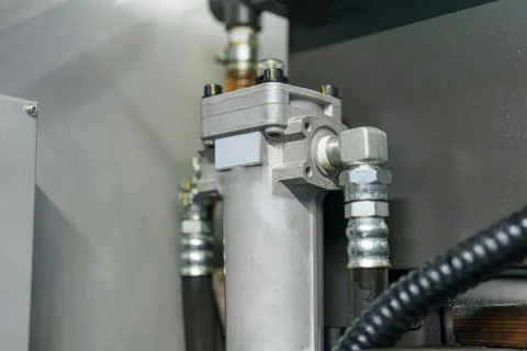 Close view of a component in a machine showing pipes and connections in an .. Stock Photos