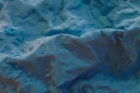 A close-up view of the compressed wrinkled rubber of a blue sea Stock Photos