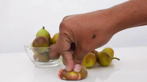 Close view of compressing fig fruit isolated over white background Stock-Footage 148215276
