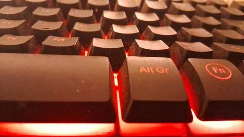 Close up view of a computer keyboard with bright red lighting Stock Photos