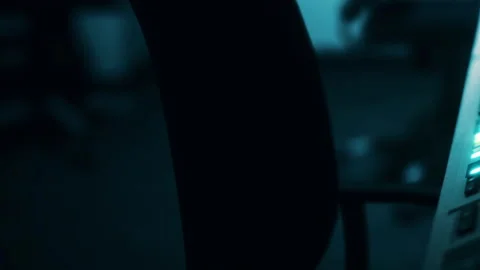 Close view of a computer keyboard in a dark room with a hand nearby Stock Footage 344968417