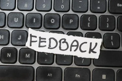 A close-up view of a computer keyboard with a handwritten note saying FEEDBACK Stock Photos
