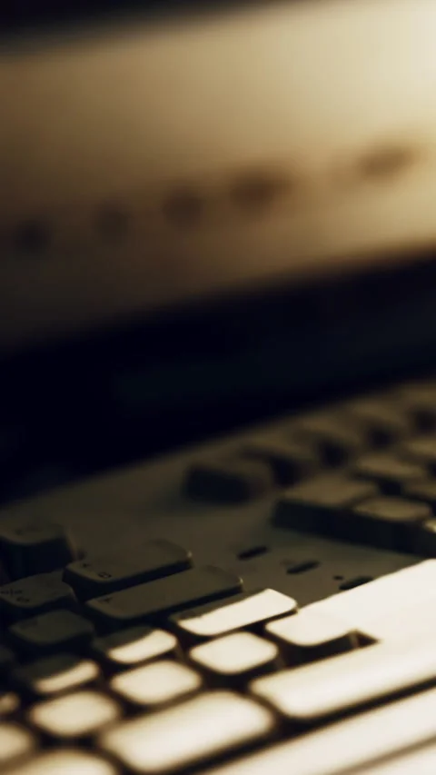 Close view of a computer keyboard in low light setting at night Stock Footage 339771752