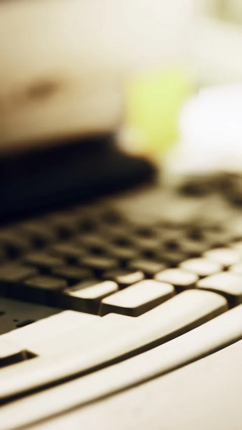 Close view of a computer keyboard in an office or home setting during the day Stock Footage 342130799