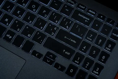 A close view of a computer keyboard shows different keys and their layout. Th Stock Photos