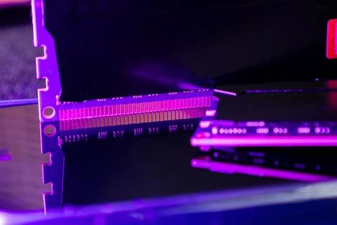 Close-up view of computer memory modules on a reflective surface with purple Stock Photos