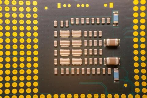 Close-up view of a computer microchip with intricate circuitry and yellow s.. Stock Photos