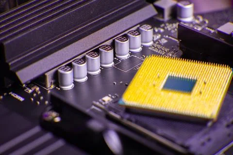 Close view of computer motherboard with CPU and capacitors in a tech setup Stock Photos