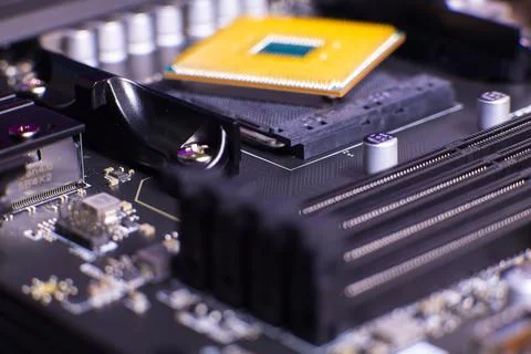 Close-up view of a computer motherboard with a CPU socket and various electronic Stock Photos