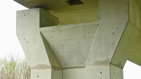 Close up view of concrete pillars holding highway bridge Stock Footage 154641668