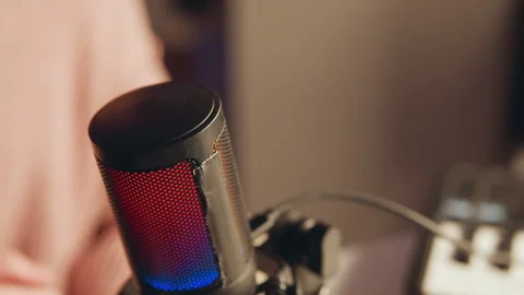 Close view of condenser microphone in shock mount with red and blue LED glow Stock Footage 345655820