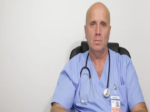 Close View Confident Doctor Image Listening and Watching to Reporter Camera Stock Footage 83640946