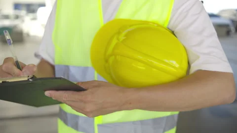 Close up view At a construction site during a work shift, an engineer in a vest 스톡 동영상 348239241