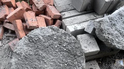 A close view of a construction site showing red bricks and gray concrete bloc Foto stock