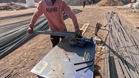 Close-Up View of Construction Worker Manually Bending Metal Rebar Rod for Stock Footage 340505662