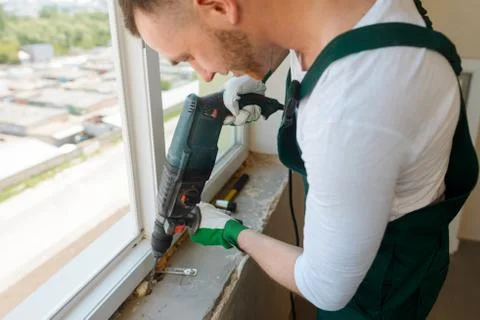 Close view on a construction worker using a rotary drill Foto stock
