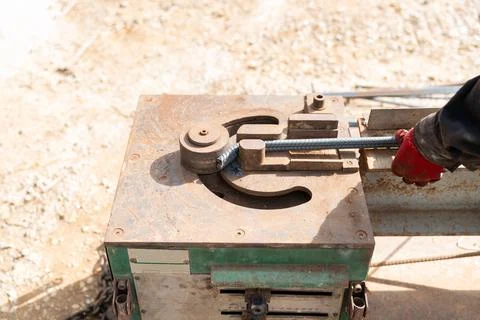 Close-up view of a construction worker using a rebar bending machine to sha.. Stock Photos