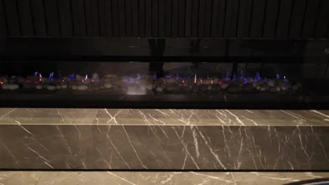 A close up view of a contemporary linear fireplace featuring colorful flame.. Stock Footage 333834622