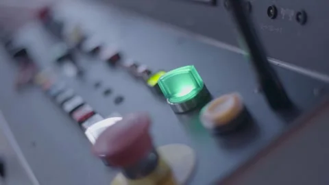 Close-up view of a control panel with illuminated green button and various 库存影片 280186031