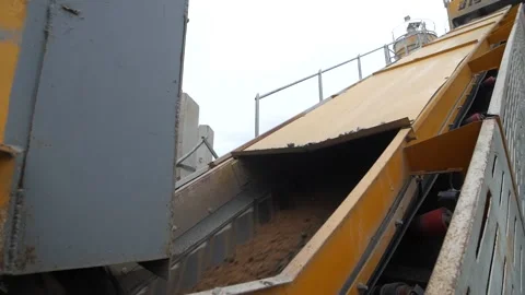 Close-up view of conveyor belt of heavy-duty equipment carrying sand Video stock 158050095