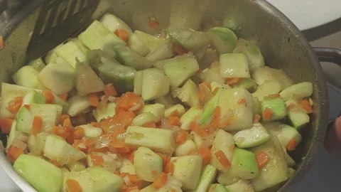 Close up view of a cook mixing sauteed vegetables like zucchini, carrots 스톡 동영상 343562355