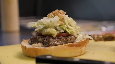 Close view cook spreads hamburger with seasoning and covers Stock Footage 104841517