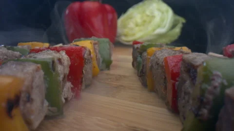 Close-up view of cooked delicious meat skewers on wood board Stock-Footage 157842813
