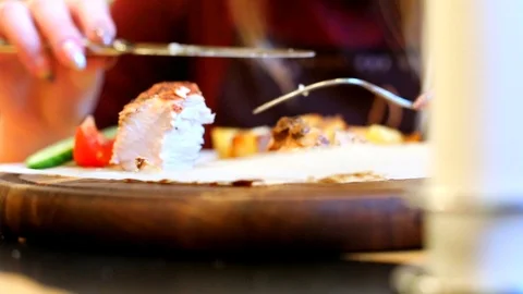 Close-up view of cooked tasty grill meat with vegetables on wooden round board.  스톡 동영상 117675326