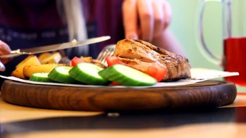 Close up view of cooked tasty red grill meat with sliced vegetables on wooden ro 스톡 동영상 117668132