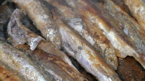 Close-up view of cooking frying capelin fish in iron pan. Grilled caplin fish - Stock Footage 139186819
