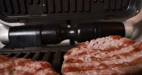 Close up view of cooking meat on electric grill Stock Footage 166512400