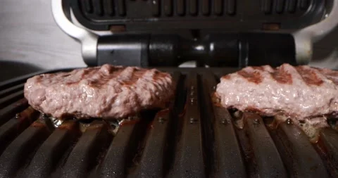 Close up view of cooking meat on electric grill Stock Footage
