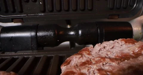 Close up view of cooking meat on electric grill Stock Footage 166822951