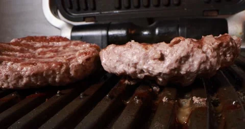 Close up view of cooking meat on electric grill Stock Footage 168060688