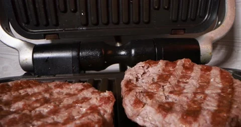 Close up view of cooking meat on electric grill Stock Footage 169873719