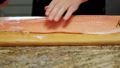 Close up view of Cooks' hands cuts the fish into pieces for further processing Stock Footage 161242044