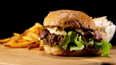 Close-up view Cool beautiful fresh juicy cooked burger rotate on turntable, Stock Footage 336579442
