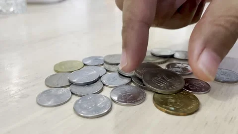 Up-Close View: Counting Malaysian Ringgit Coins on a Wooden Table. Stock-Footage 319983912