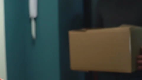 Close-up view of courier service man delivering package to client on doorstep at Video stock 146593162