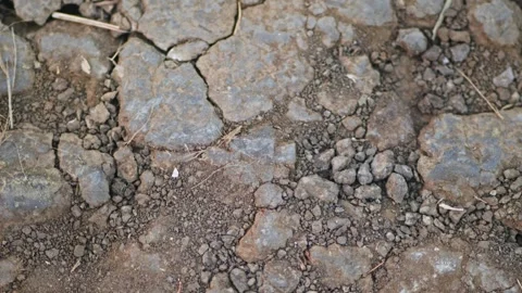 Close-up view of cracked dry soil and rough ground texture, showing natural 스톡 동영상 331026625
