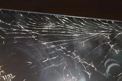 A close-up view of a cracked screen showcasing intricate patterns of damage.. Stock Photos