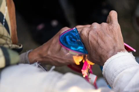 Close Up View Of Craftsman Hands Heating Plastic Component For Toy Windmill.. Stock Photos