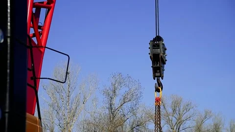 Close-up view of the crane hook against the blue sky Stock Footage 220617722